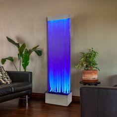 a living room filled with furniture and a tall blue light