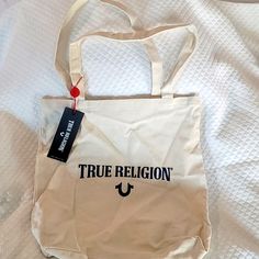 True Religion Nwt Canvas Tote Beige Cotton Bag With Logo, Beige Cotton Bags With Logo, Casual Beige Bag With Logo, Casual White Bag With Logo, Casual White Bags With Logo, Casual Bags With Logo For Shopping, Tan Cotton Bags For Daily Use, Casual Logo Shoulder Bag For Shopping, Casual Shoulder Bag With Logo For Shopping