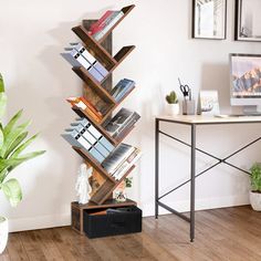 a wooden book shelf sitting on top of a hard wood floor next to a plant