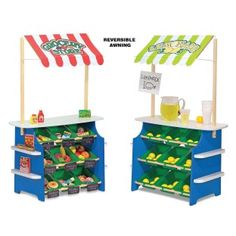 two children's toy food stands with signs on them and an advertisement for the store