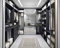 a walk - in closet with black cabinets and white carpeted flooring is shown