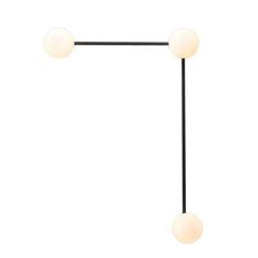 the three light floor lamp is black and has two white balls on each side of it