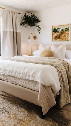 a bedroom with a bed, nightstands and plants hanging on the wall above it