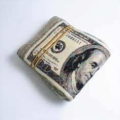 a money bill is sitting on top of a pillow