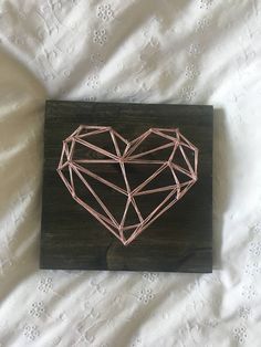 a piece of wood that has some kind of heart on it