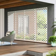 an outdoor area with a chair and potted plants on the side of the building