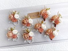 a bunch of flowers that are sitting on a white table cloth with a name tag