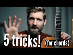 a man with a beard holding an acoustic guitar and the words 5 tricks for chords