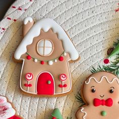 three decorated gingerbread cookies sitting on top of a table