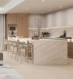 a modern kitchen with marble counter tops and bar stools next to the living room