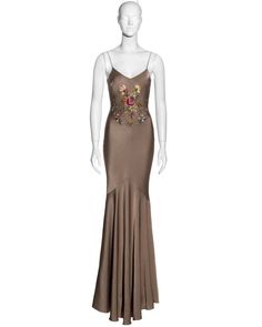 For Sale on 1stDibs - ▪ John Galliano bias-cut evening dress ▪ Taupe crepe-backed satin ▪ Floral embroidery at the front and back ▪ Floor-length skirt with train ▪ Silk trim Embellished Satin Gown For Gala, Embellished Satin Evening Gown, Embroidered Satin Evening Dresses, Embroidered Satin Party Gown, Elegant Embroidered Satin Dress, Embroidered Silk Evening Gown, Embellished Satin Maxi Gown, Embellished Fitted Satin Gown, Fitted Embellished Satin Gown