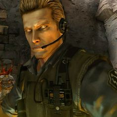 a man wearing a headset in front of a stone wall with fire coming from it