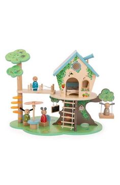 a wooden toy house with trees and people