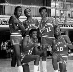 an old black and white photo of basketball players posing for a team photo on the court