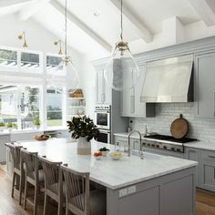 a large kitchen with an island in the middle and lots of counter space on one side