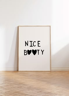 a black and white poster with the words nice body on it in front of a wooden floor