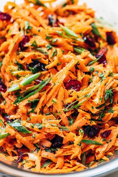 carrot salad with cranberries and green beans in a bowl