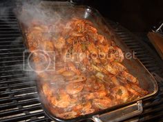 shrimp being cooked on the grill with steam coming from it's bottom and sides