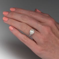 a woman's hand with a diamond ring on it