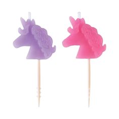 two pink and purple unicorn lollipops sitting on top of each other