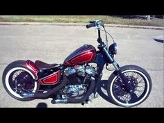 a red and black motorcycle parked on the street