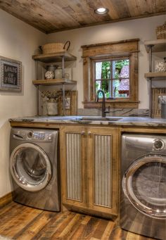 a washer and dryer in a room with wood flooring on the walls