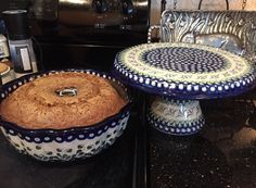 two blue and white dishes sitting on top of a counter next to a toaster oven