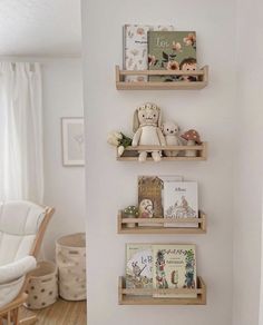 three wooden shelves with books and stuffed animals on them in a child's room