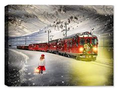 a woman standing in the snow next to a train with christmas decorations on it's side