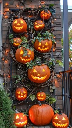 pumpkins are lit up on the side of a house