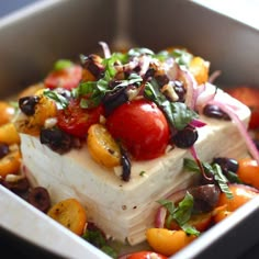 a square dish filled with lots of vegetables