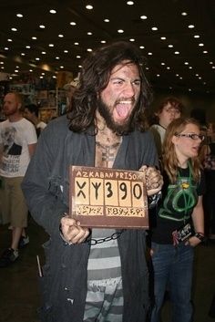 a man with long hair and beard holding up a plaque that says 99 9x