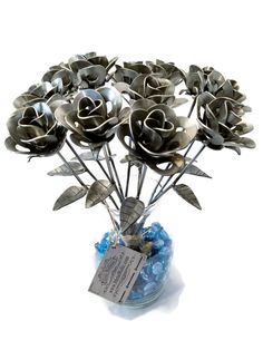 a vase filled with lots of metal flowers