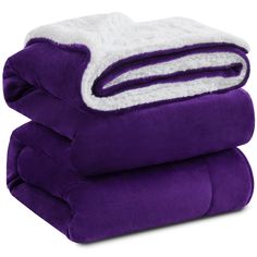 three purple and white blankets stacked on top of each other