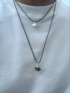 Discover our exquisite pair featuring silver metal charms on adjustable black cords, suitable for every man. The first necklace showcases a silver tiny fish charm, while the longer piece features a seashell charm with black lines. Wear them individually or together for a unique style. Available exclusively at Christina Christi Store. 👉My Mens Necklaces Collection: https://etsy.me/2P4MaeV 👉 Express Shipping: https://etsy.me/3ikUnOM MATERIALS - Black Cord. - Charms are made from brass. - Enamel Beach Jewelry For Men, Minimalist Silver Necklace With Waxed Cord, Silver Necklace With Waxed Cord For Gift, Silver Waxed Cord Necklace For Gift, Adjustable Black Sterling Silver Charm Necklaces, Black Sterling Silver Necklace With Adjustable Cord, Silver Necklaces Men, Summer Necklaces, Necklaces Collection