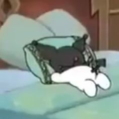 a cartoon character laying on top of a bed