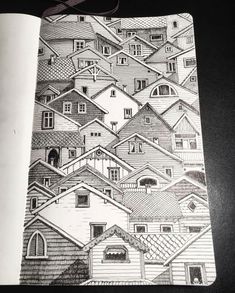 a notebook with houses drawn on it