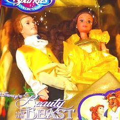 the doll is in its box and has an image of beauty and the beast on it