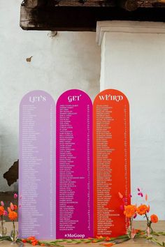 an image of a table setting with flowers and seating chart on the back side in bright colors