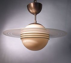 a light fixture hanging from the ceiling in a room with gray walls and flooring