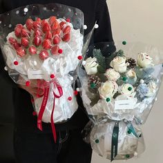 a person holding two bouquets of flowers in their hands, one wrapped in plastic and the other wrapped in wrapping