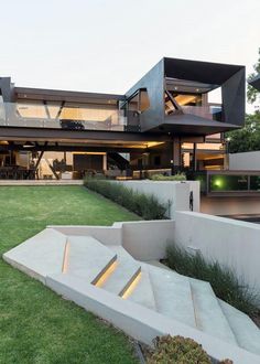 an exterior view of a modern house with stairs leading up to it