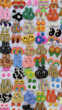 many different types of buttons and magnets on a white surface