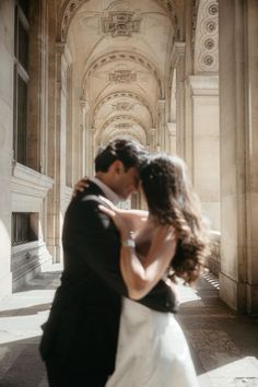 a bride and groom standing in an archway