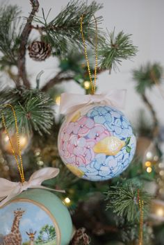 an ornament hanging from the top of a christmas tree with decorations on it