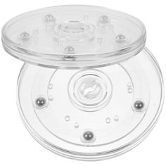 a clear plastic object with four holes on the front and one hole in the middle