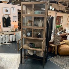 a room filled with lots of furniture and decor on top of carpeted flooring