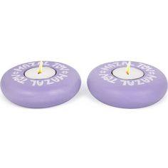 two purple candles sitting on top of each other