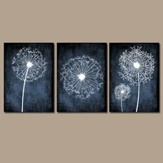 three black and white dandelions on a wall