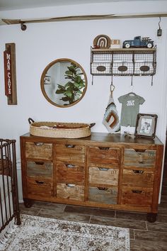 a baby crib in the corner of a room next to a dresser and mirror